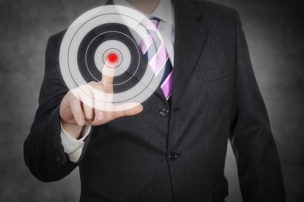 Man holding finger up to bullseye target