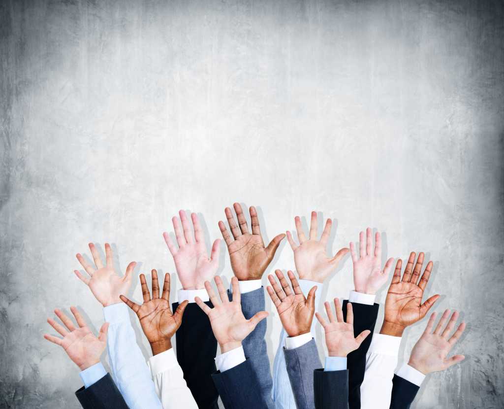 Group of hands raised to volunteer