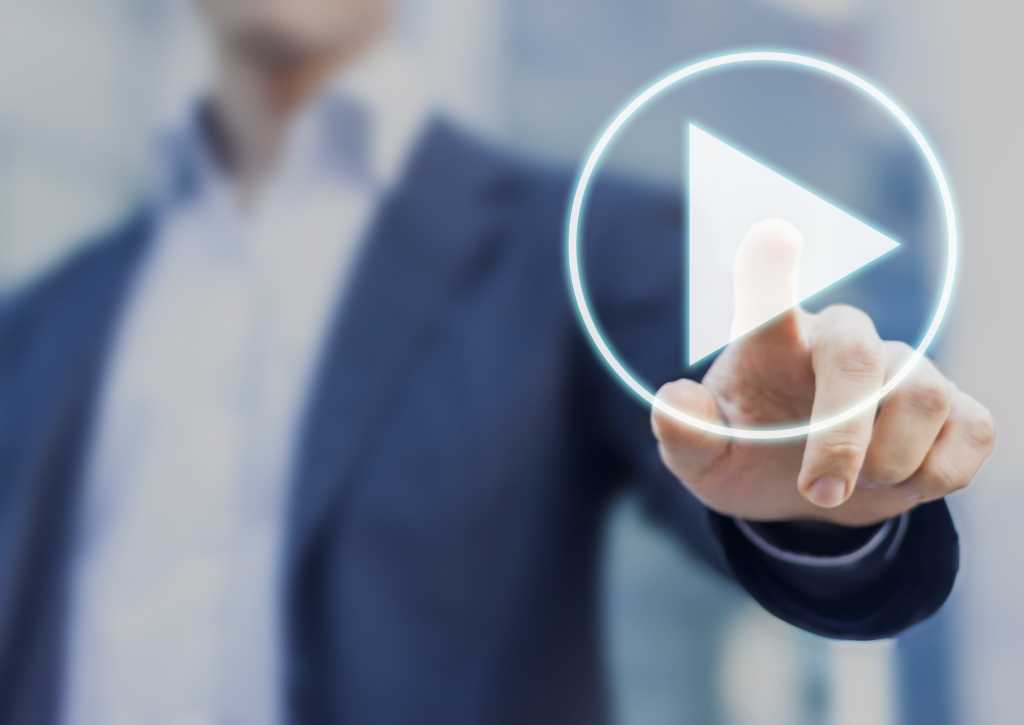 executive pointing to video play button icon