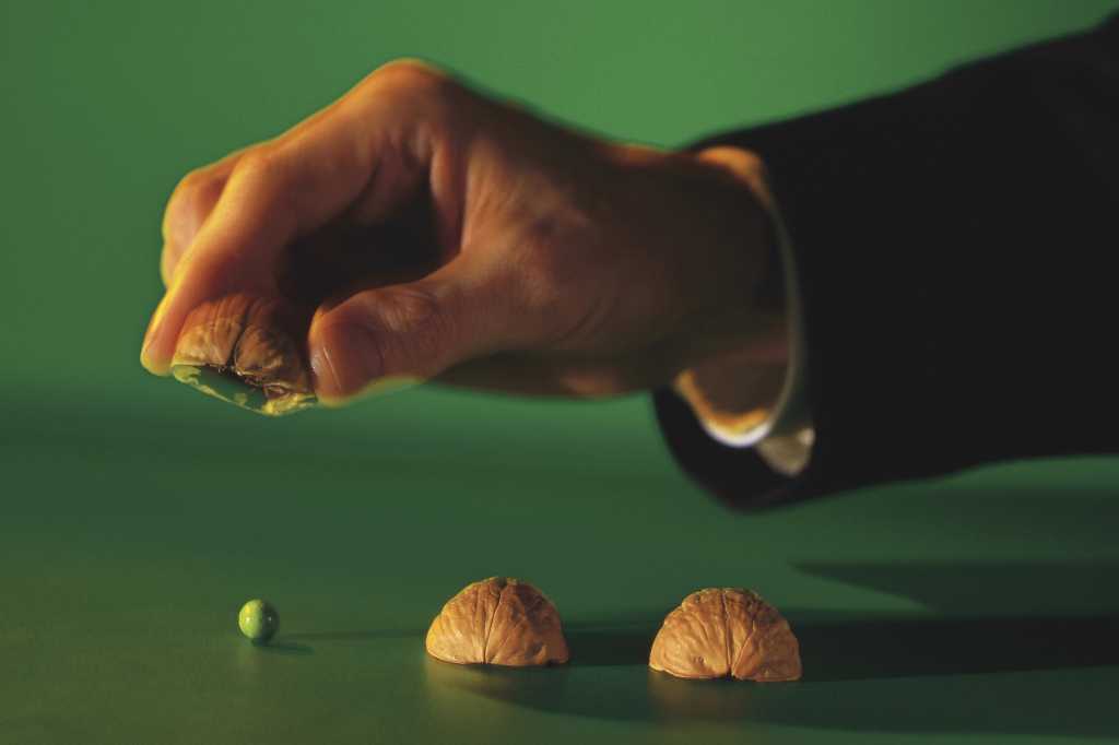 Hand playing shell game 3 card monte
