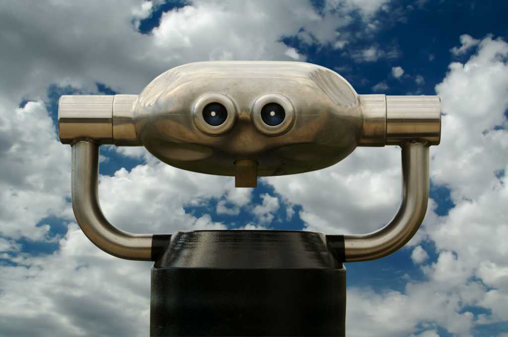 Public binoculars against cloudy sky