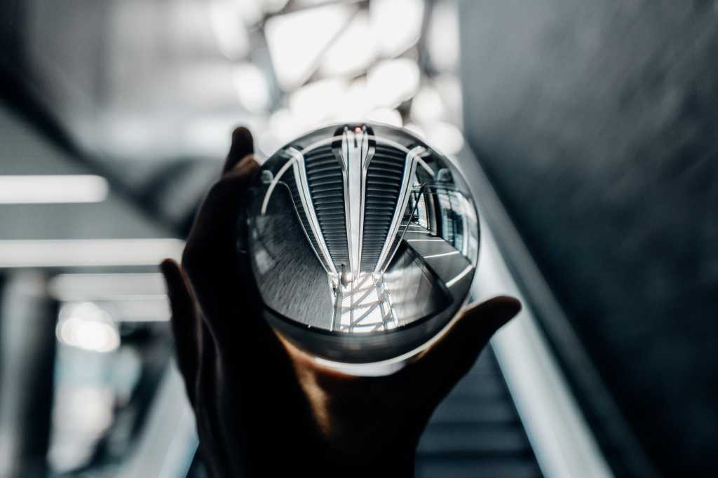 Upside-down / inverted view of escalators  through a crystal ball [future/forecast/possibilities]