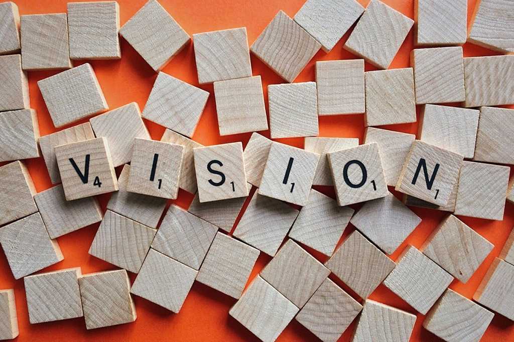 alphabet letter tiles spell 'vision'