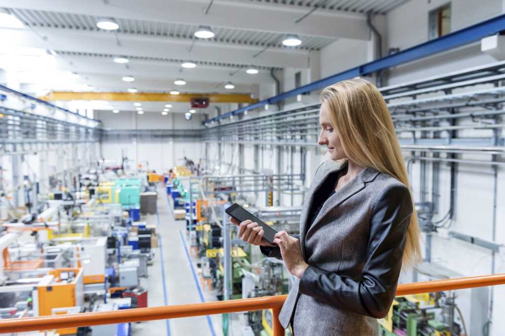 working with tablet in futuristic factory 000092418221 medium