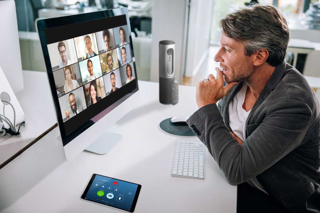 Zoom video conferencing > One user connected via laptop showing a grid of remote participants.