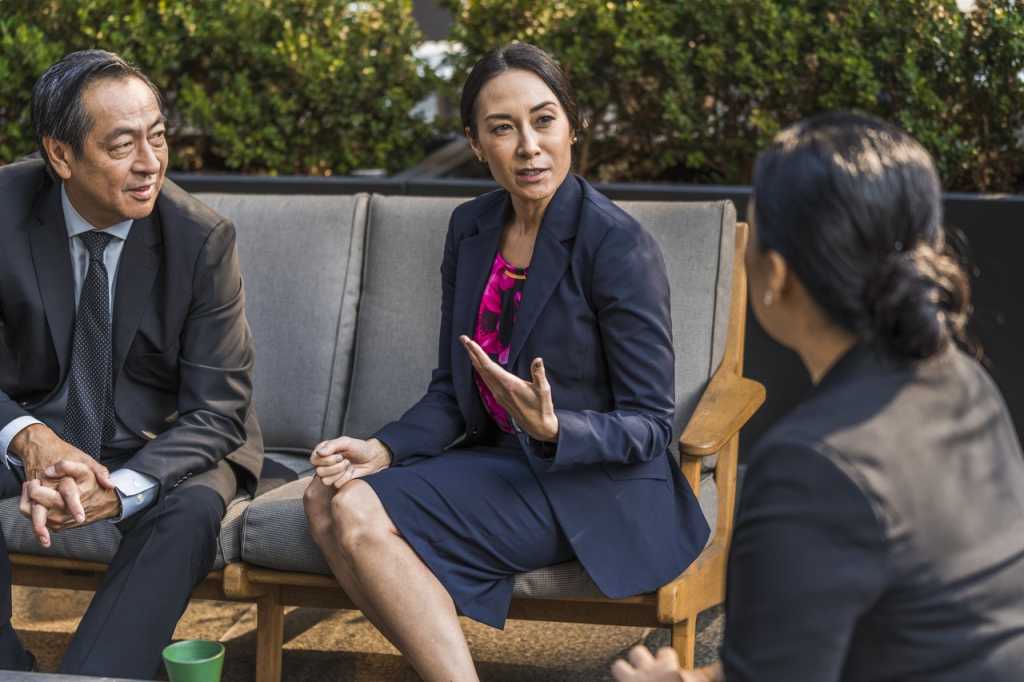 Asian professionals at an outdoor meeting discussion