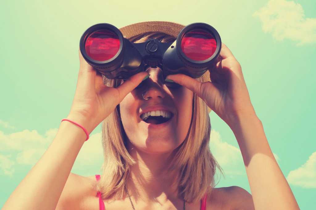 women looking through binoculars future vision prediction millennial