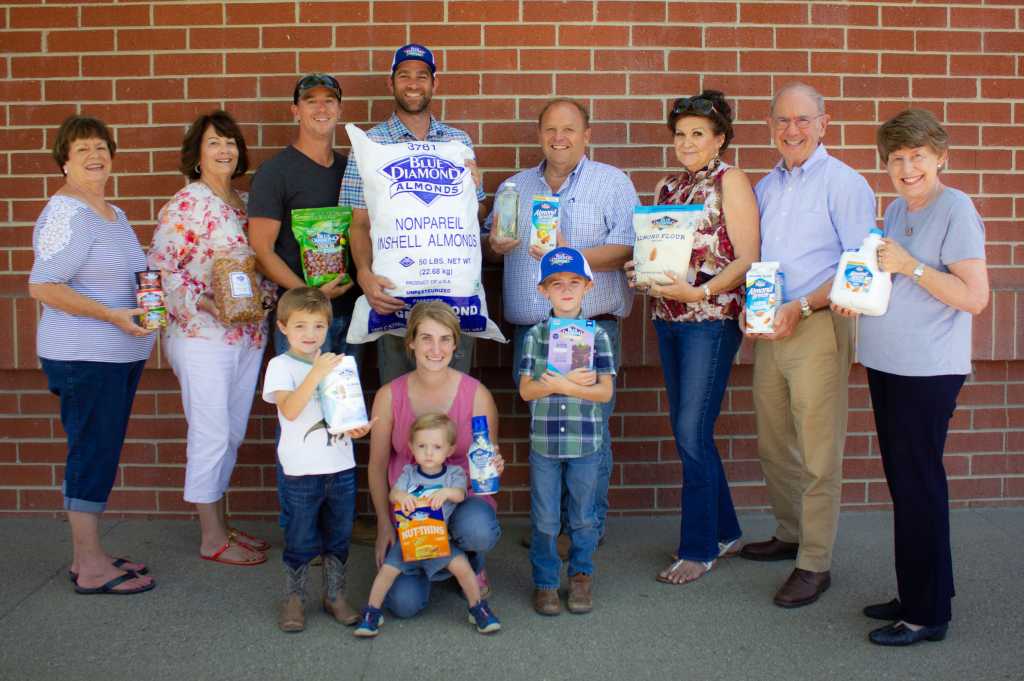 Blue Diamond Growers posing in front of brick wall with product