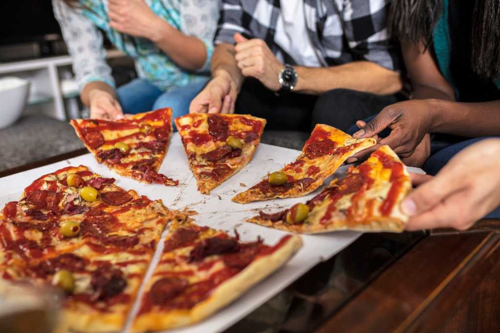 group of friends sharing pizza