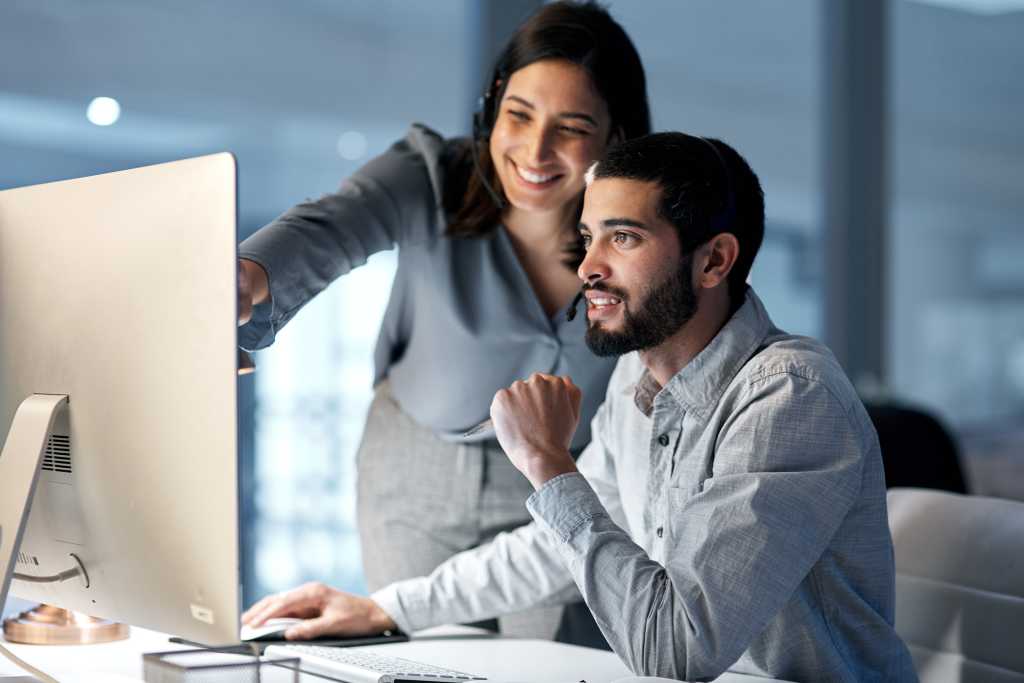 Shot of a young woman helping her colleague
