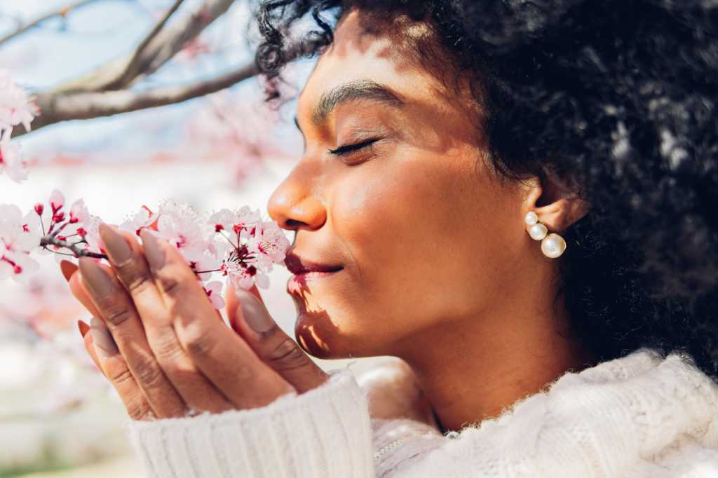 woman smelling flowers