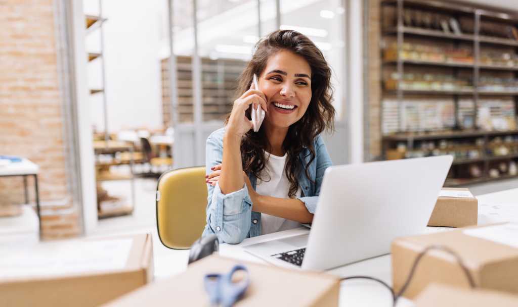 businesswoman speaking on the phone in a warehouse