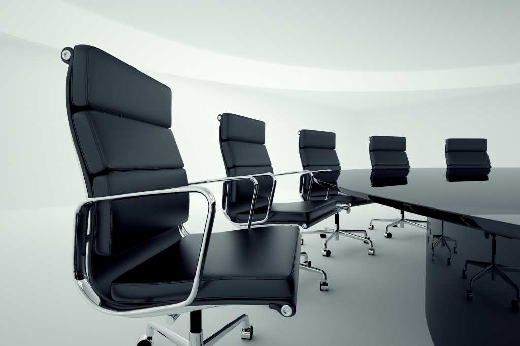 Row of empty boardroom chairs