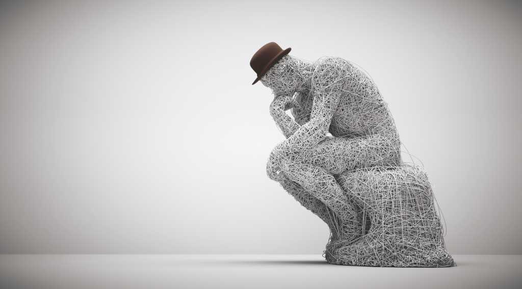 Thoughtful man sitting down. Confusion and overthinking concept