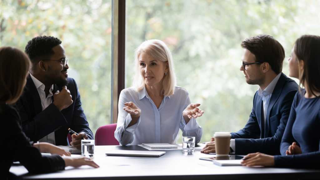 woman speaking with colleagues
