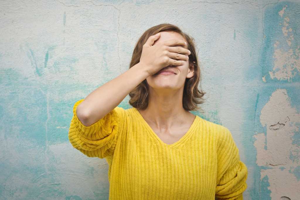 woman with hands over face mistake oops embarrassed shy by marisa9 getty