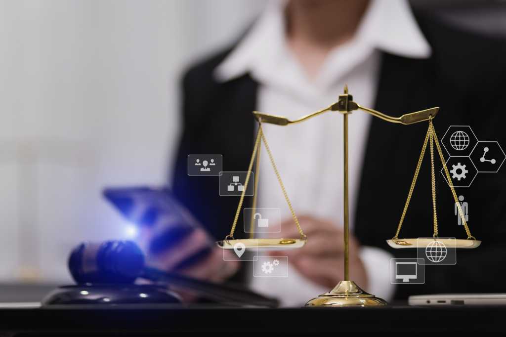Lawyer hands using digital smartphone with law network interface icons