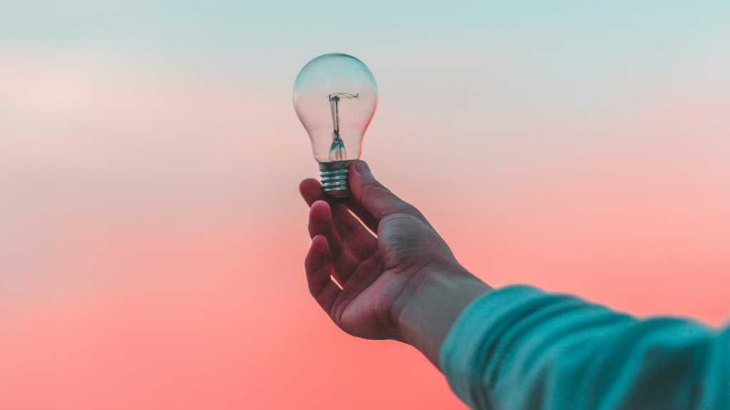 person holding lightbulb