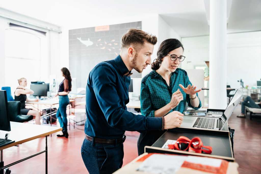 man and woman conferring office