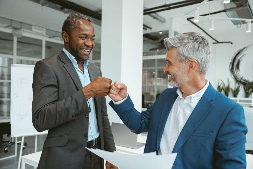 Business male partnership handshake.