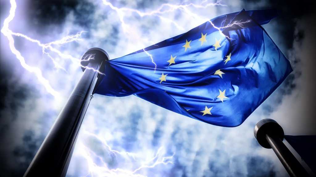 European Union flag on dark thunderstorm sky background
