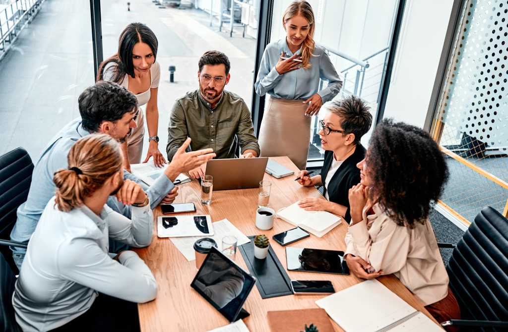 Negotiating on project. Corporate experts in formalwear sitting around table and talking about necessary task. Sales team making decisions about price regulation with account of inflationary expenses.