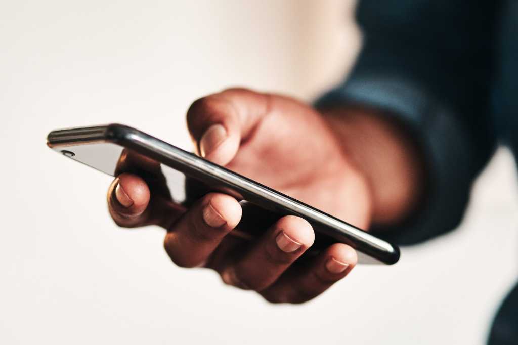 diversity south africa man holding smartphone mobile technology connected by peopleimages gettyimag