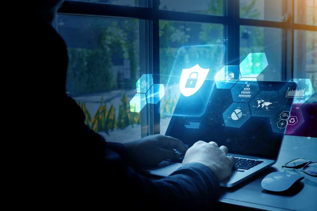 Tech Spotlight   >   The Future of Work [CSO]   >   Laptop user with virtual security overlay.