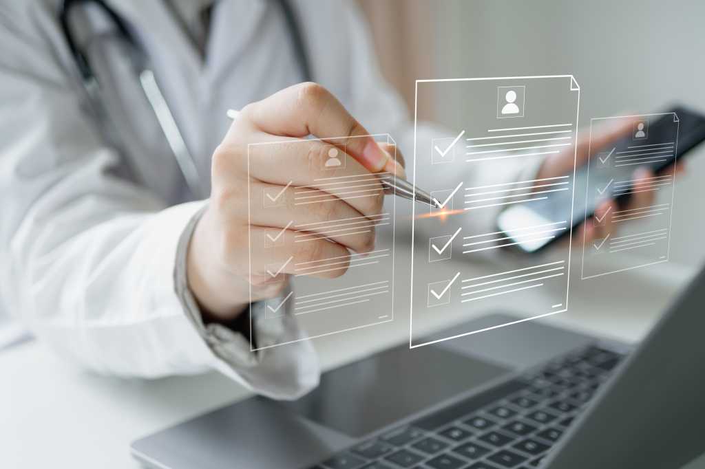 Medicine doctor use laptop to review patient medical records on virtual screen