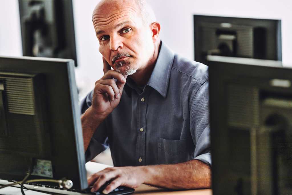 man at computer listens to you skeptically - I am not convinced of what you say, prove it! - among technicians and scientists fortunately the burden of proof is on the person making the claim