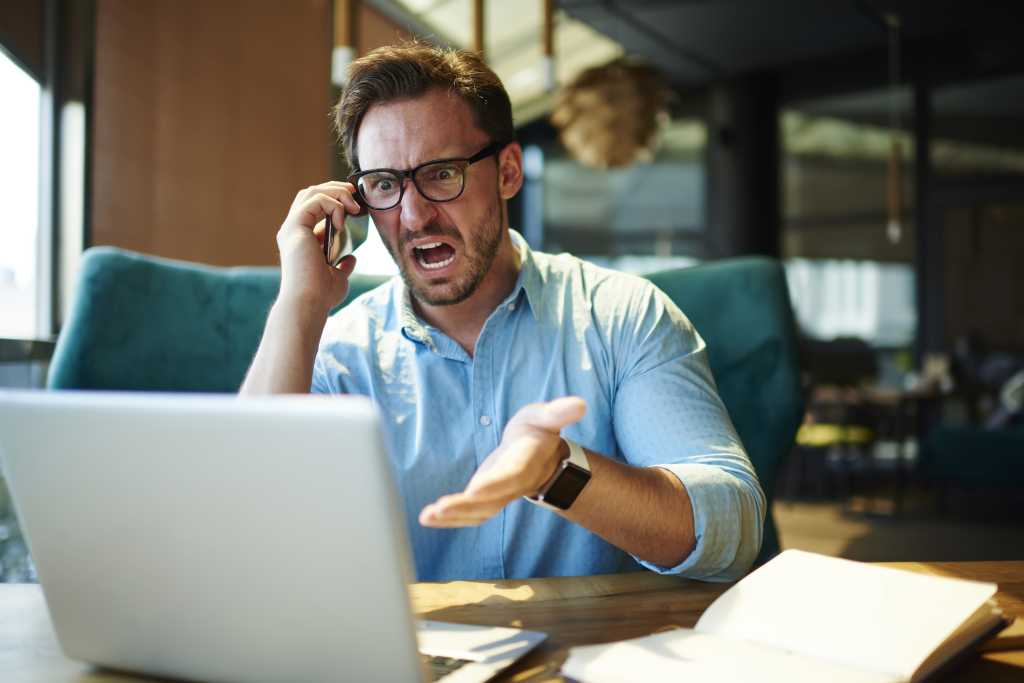 Experienced executive manager quarreling with employee on mobile yelling and screaming about bad report and failure with project, mad boss angry about software bugs in application for work
