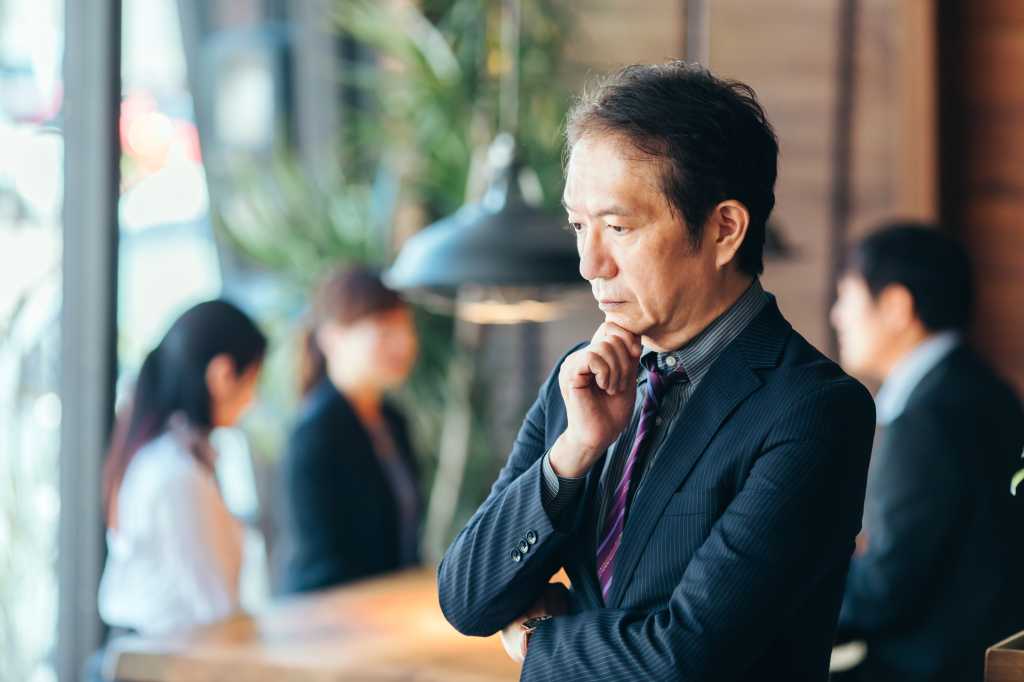 A middle-aged businessman in a troubled suit
