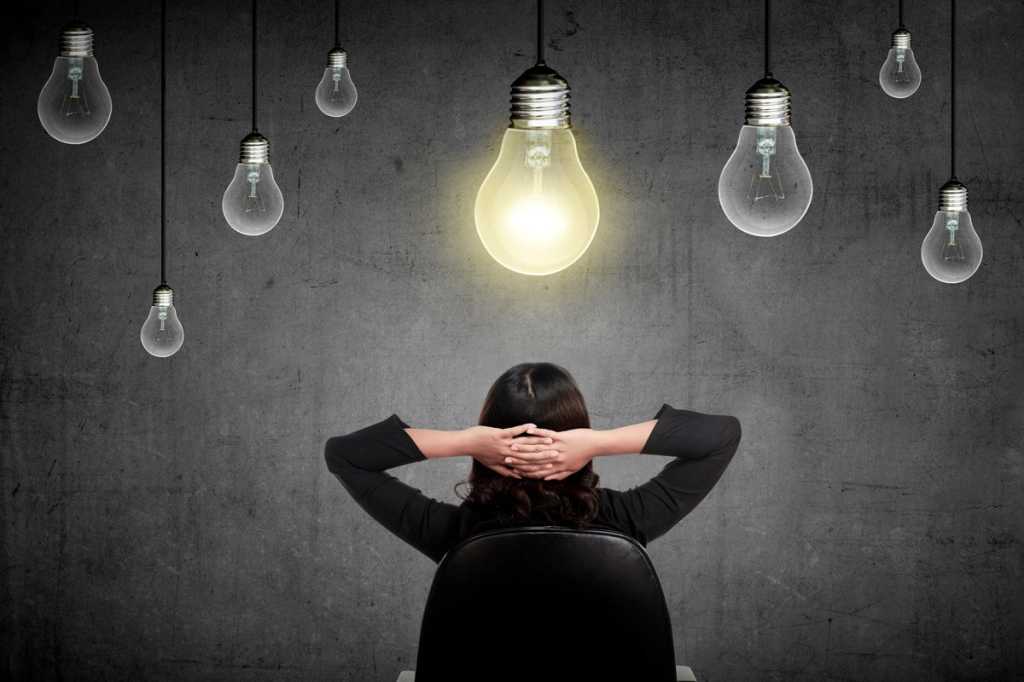 innovation idea lightbulb woman under light bulb woman thinking