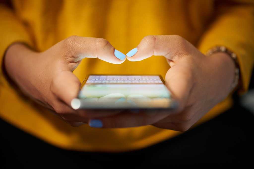 Close-up shot of a mobile user's hands and phone  >  messaging / texting