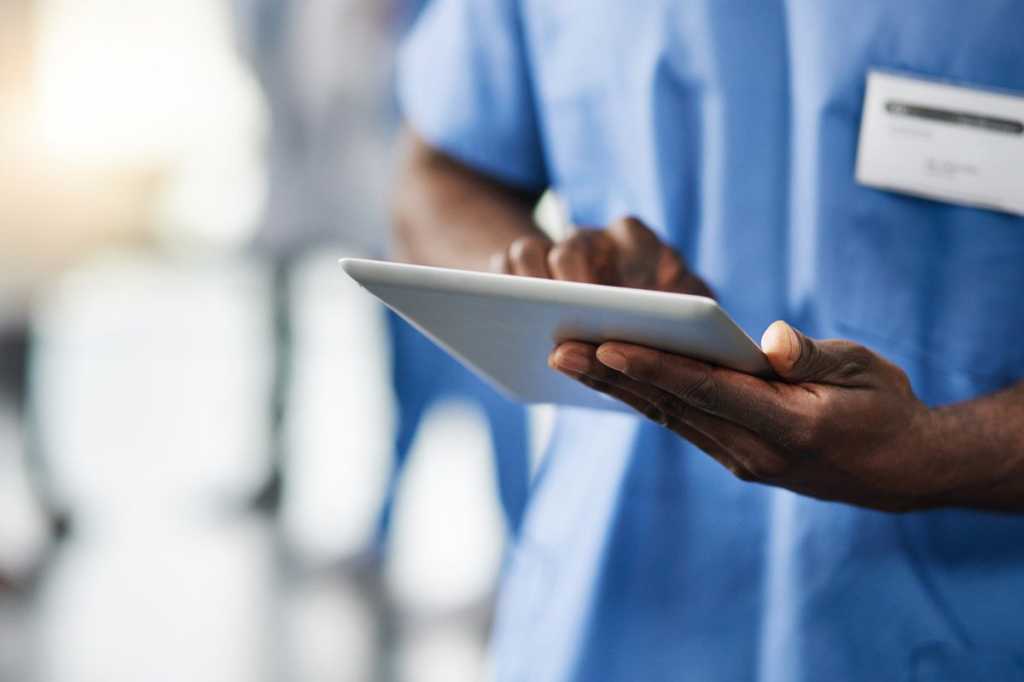 doctor with tablet nurse scrubs mobile device medical technology