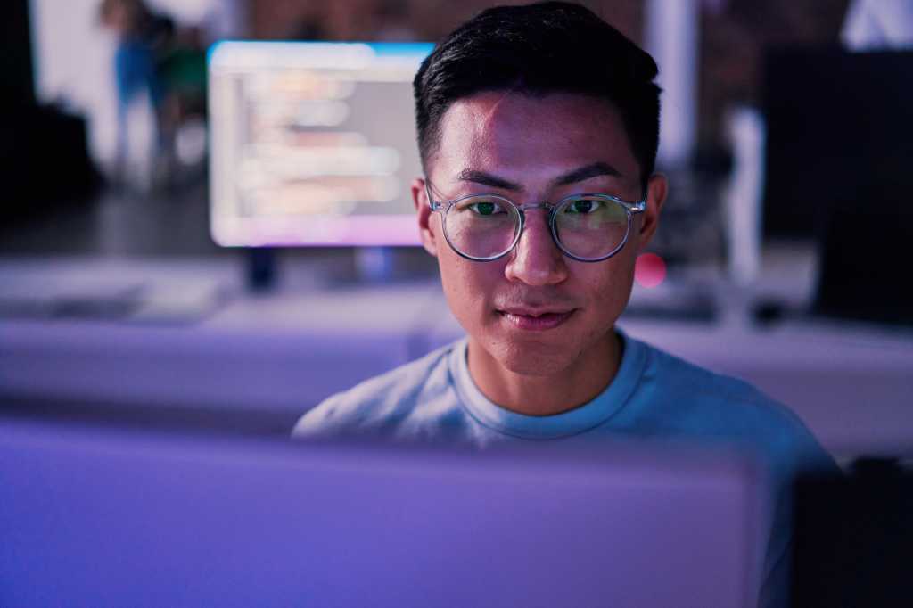 Businessman, computer or programming code in night office for software development, cybersecurity or database safety.