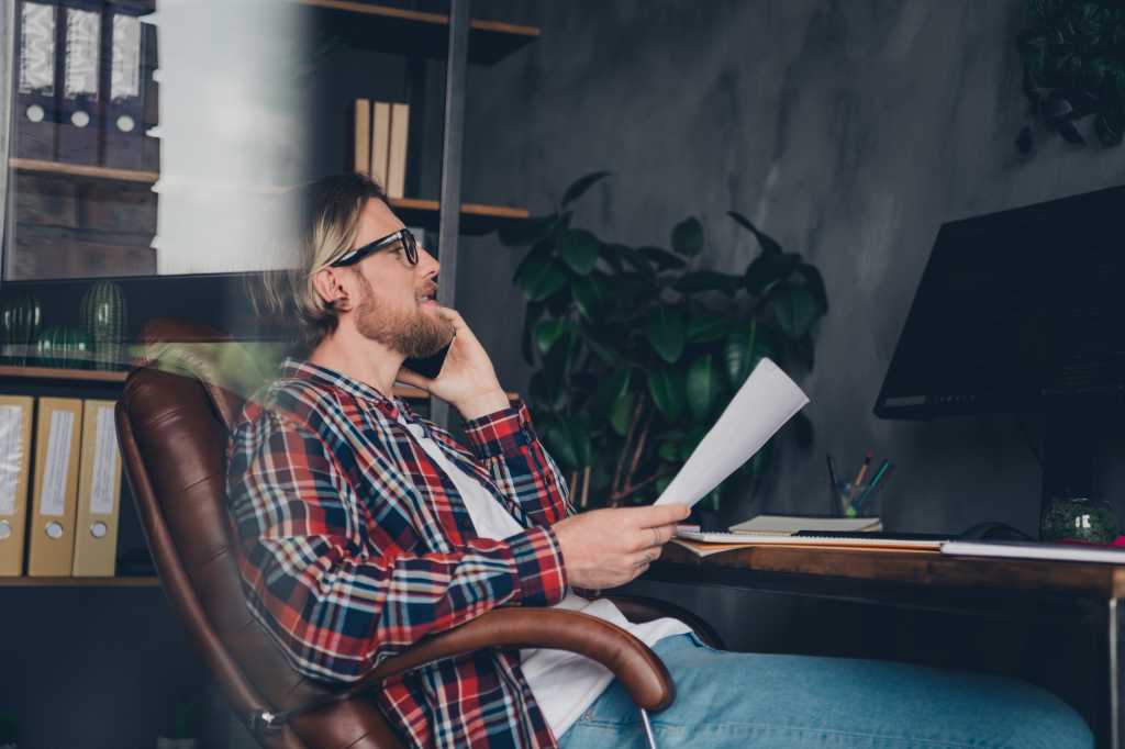 Photo of professional hr manager young man sitting boss armchair calling his assistant for list important things in his ceo workplace room