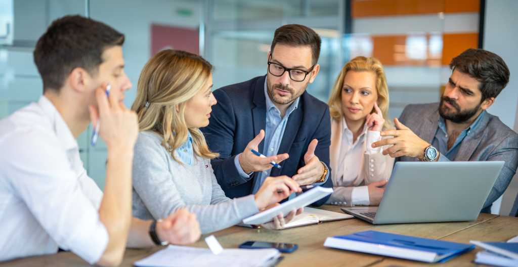 CEO manager explaining to business associates how to overcome the company's crisis by presenting new ideas during a meeting in the conference room.