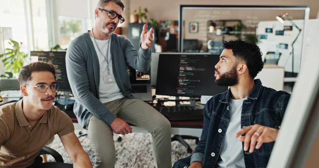 Programmer, mentor and presentation with business people in office for website developer, coding bootcamp and review. Planning, collaboration and software engineer with employees in tech startup