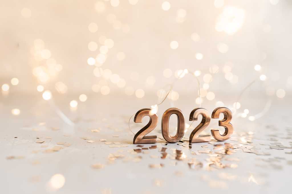 happy new year 2023 background new year holidays card with bright lights,gifts and bottle of champagne