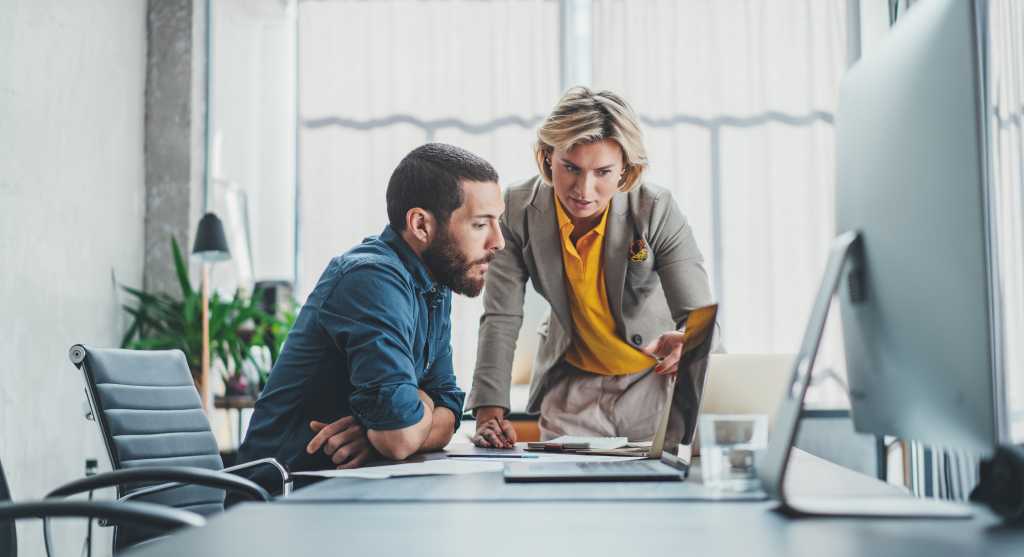 Business team making conversation at sunny meeting room
