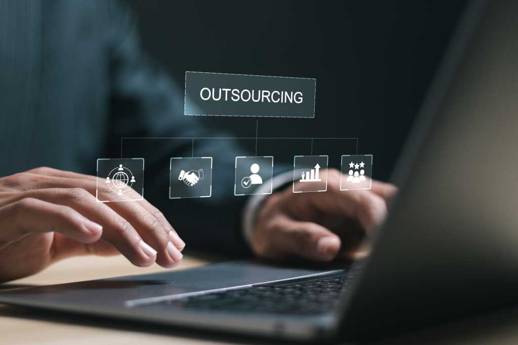Outsourcing concept. Human resources and global recruitment for business. Businessman use laptop with virtual outsourcing icon for business working and company.