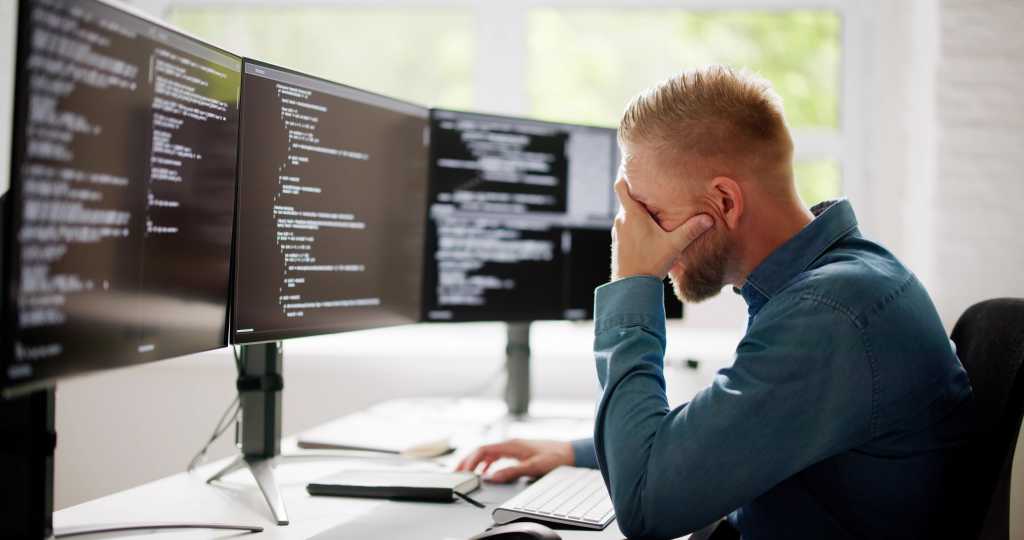 Coder Using Computer At Desk. Web Developer