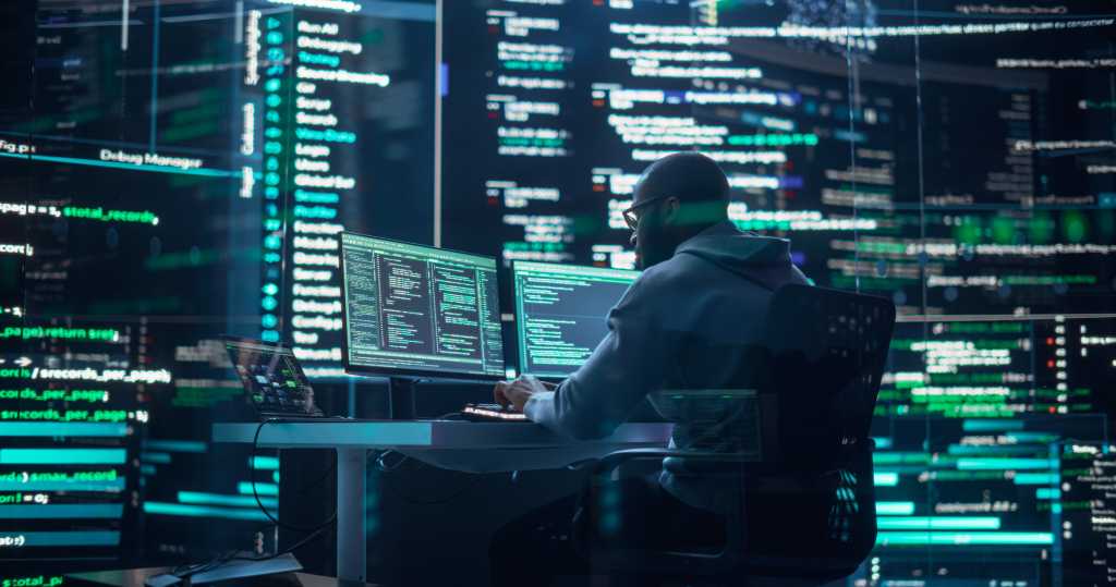 Developer Thinking and Typing on Computer, Surrounded by Big Screens Showing Coding Prompts. Professional Programmer Creating Software, Running Coding Tests. Futuristic Programming