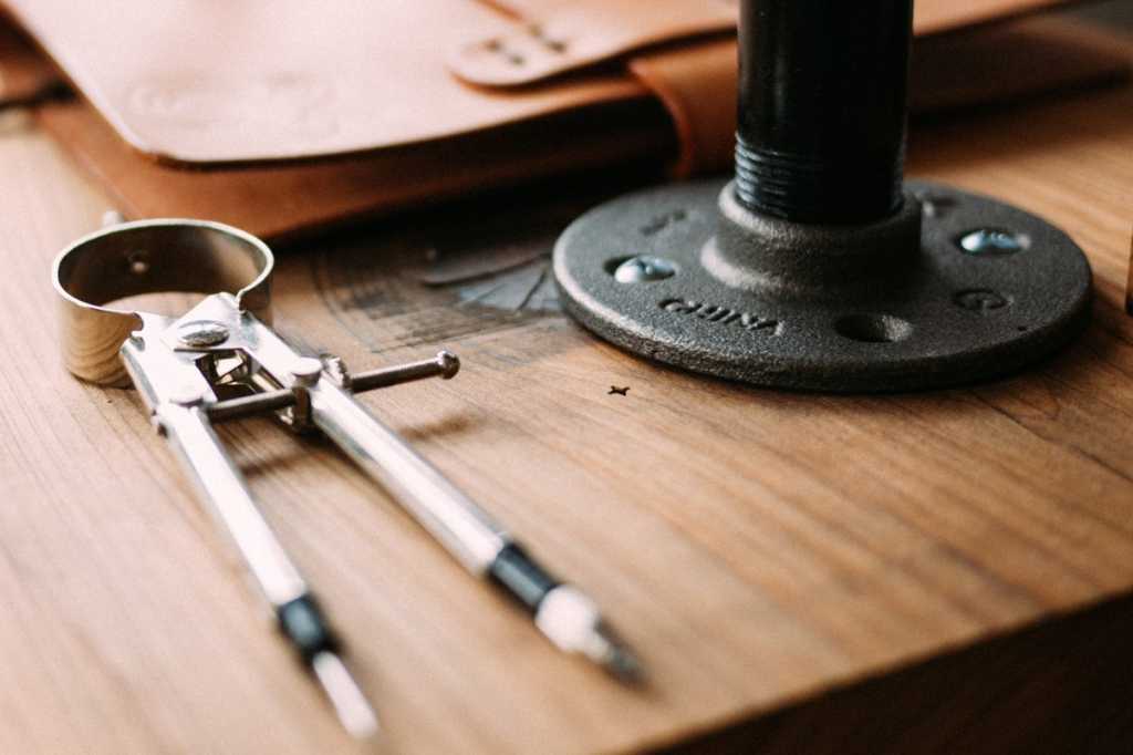 architecture architectural tools wood grain compass photo by jeff sheldon on unsplash