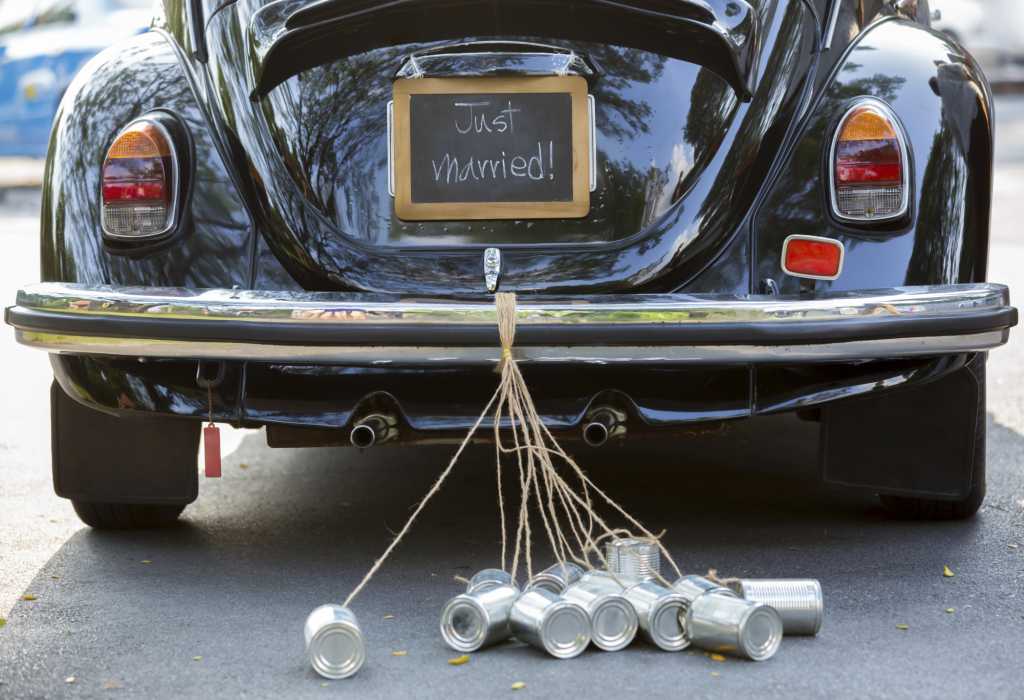 Black VW Beetle with Just Married sign and trailing cans