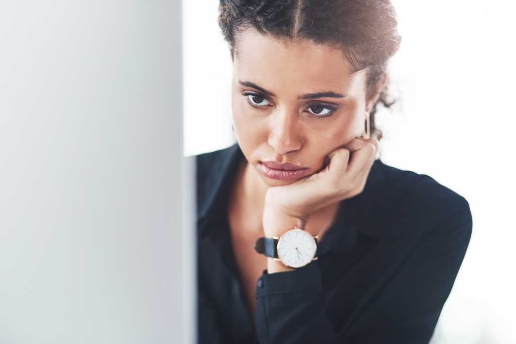 Woman, employee and sad on computer in office for internet or online error with research for ideas. Female person, pc and stress or tired with burnout from deadline, project or task as copy writer