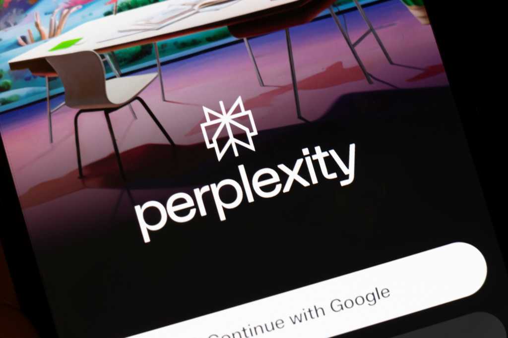Warsaw, Poland - March 10, 2025: A close-up of a smartphone screen showcasing the Perplexity app logo, set against a modern workspace background. Colorful art decorates the space