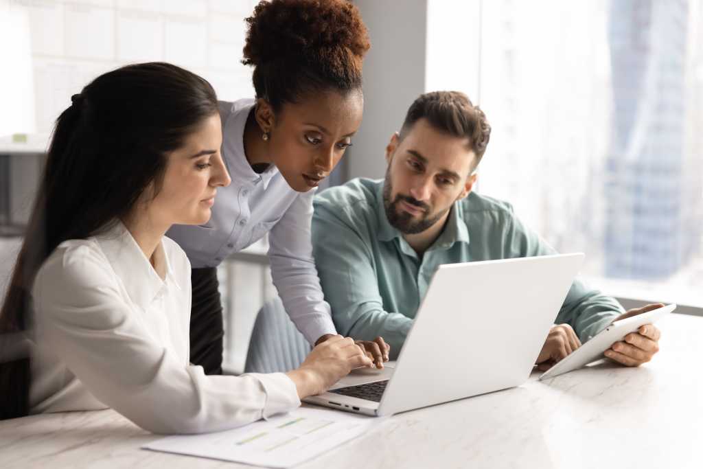 people at office looking at laptop
